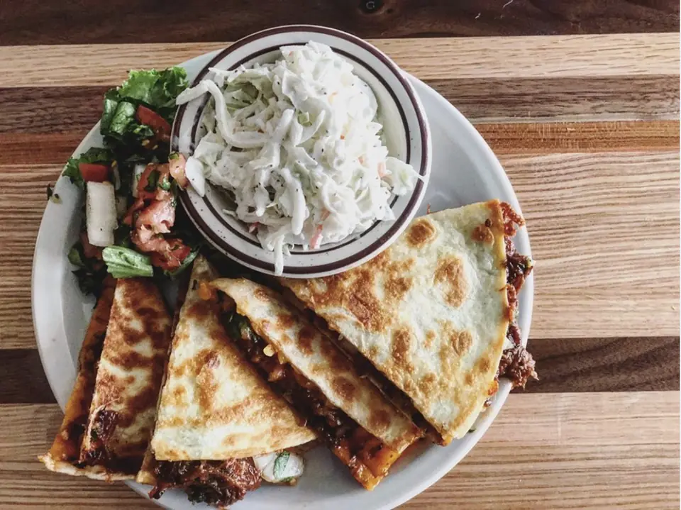 Quesadilla with coleslaw on a plate